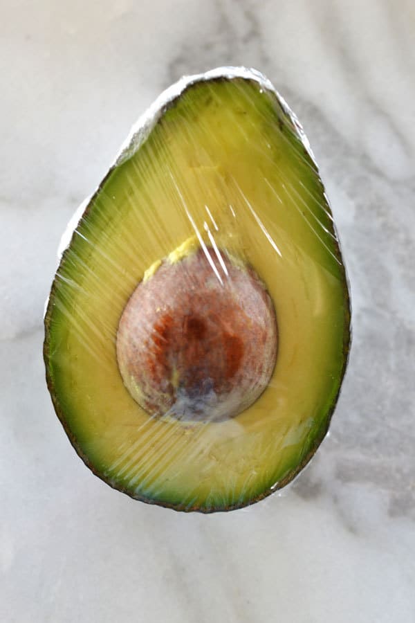 half an avocado wrapped in plastic wrap