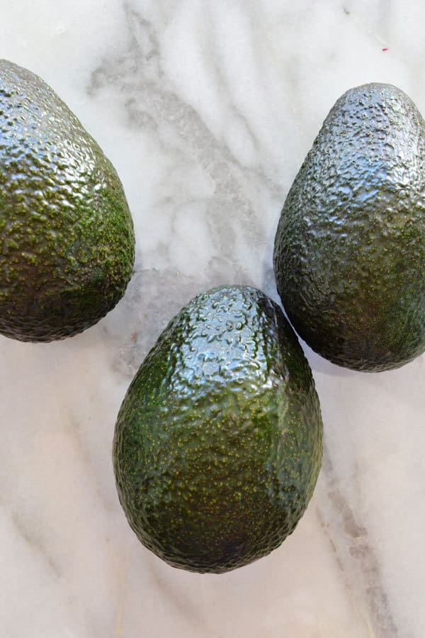 3 avocados stored on the counter