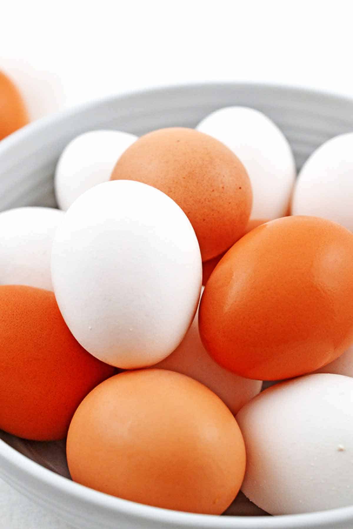 Bowl of fresh brown and white eggs.