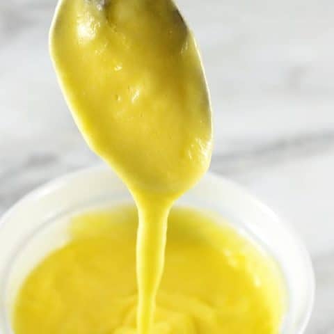hollandaise sauce dripping off a spoon