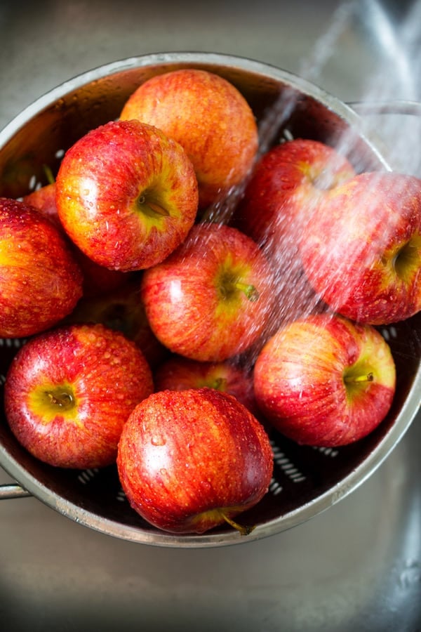 apples being washed in sink