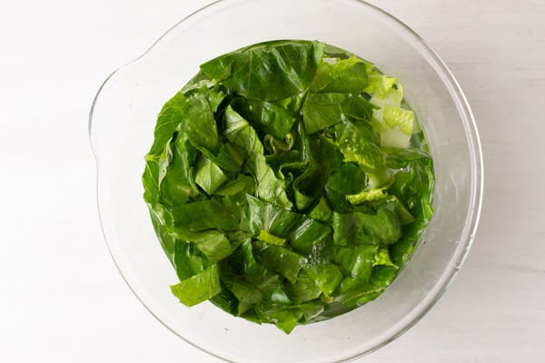 lettuce soaking in bowl of water