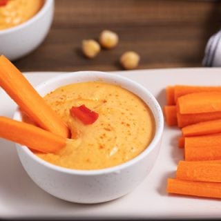 bowl of hummus and carrot sticks