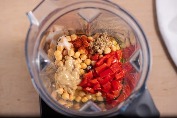 Vitamix with chickpeas, roasted red peppers, tahini, flax seed and salt