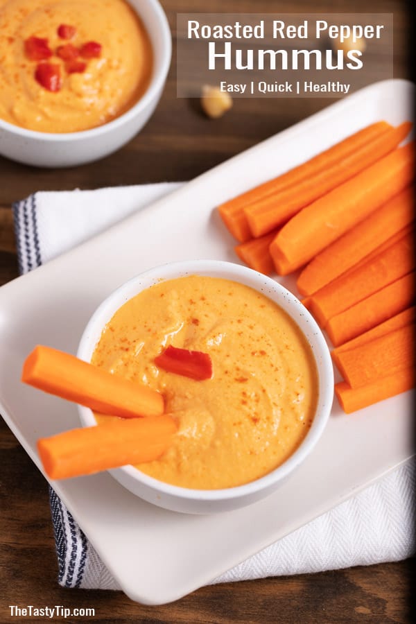 bowl of roasted red pepper hummus and carrot sticks