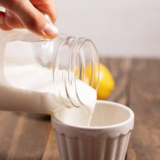 pouring buttermilk into a cup