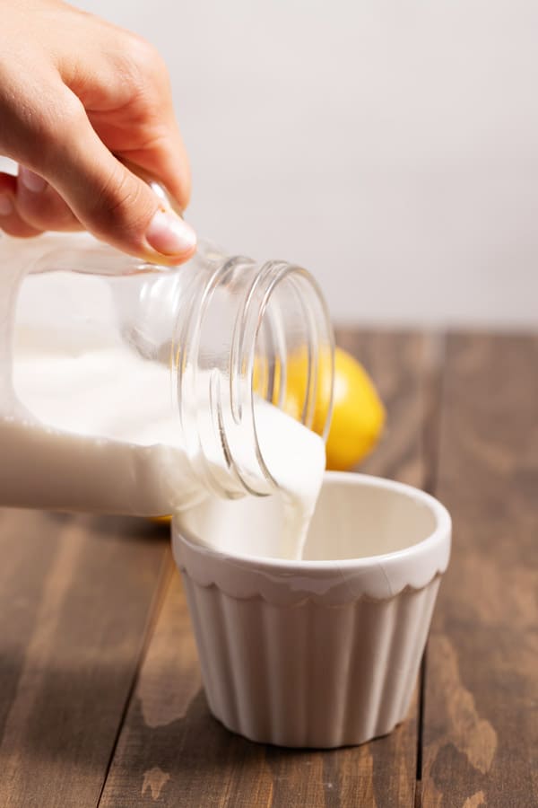 pouring buttermilk into a cup