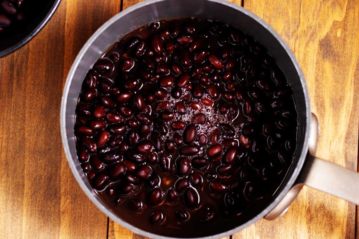 Cooked black beans in a pot.