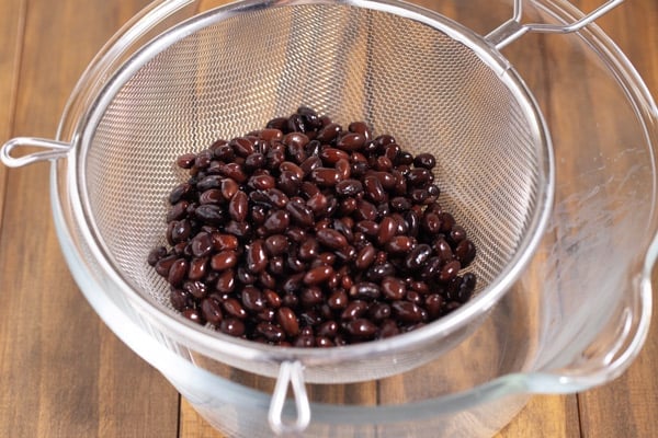 cooked black beans in a strainer