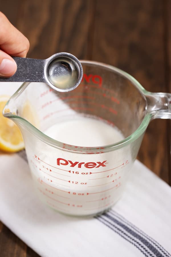 pouring lemon juice into milk