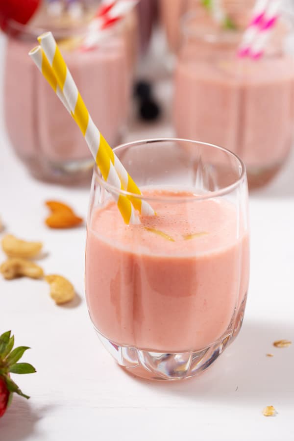 glass of smoothie with pineapple strawberry banana