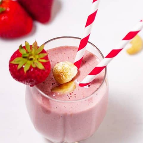 glass of strawberry banana smoothie with straw