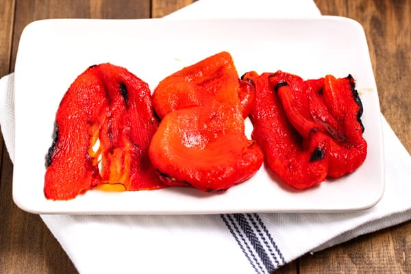 roasted red peppers skinned and on a plate