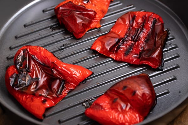 red peppers on a grill pan after being roasted