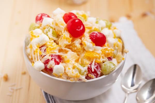 bowl of ambrosia salad with cherries on top