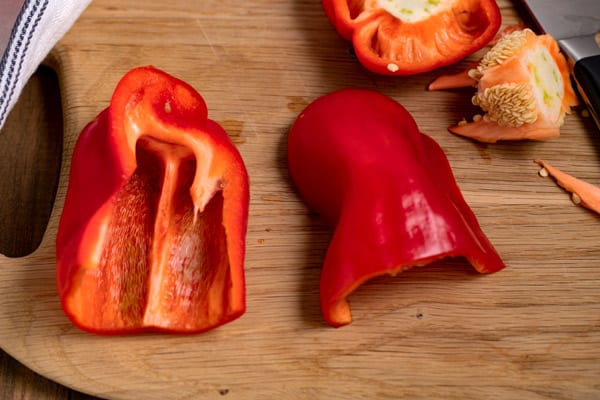 red peppers cut in half on a cutting board