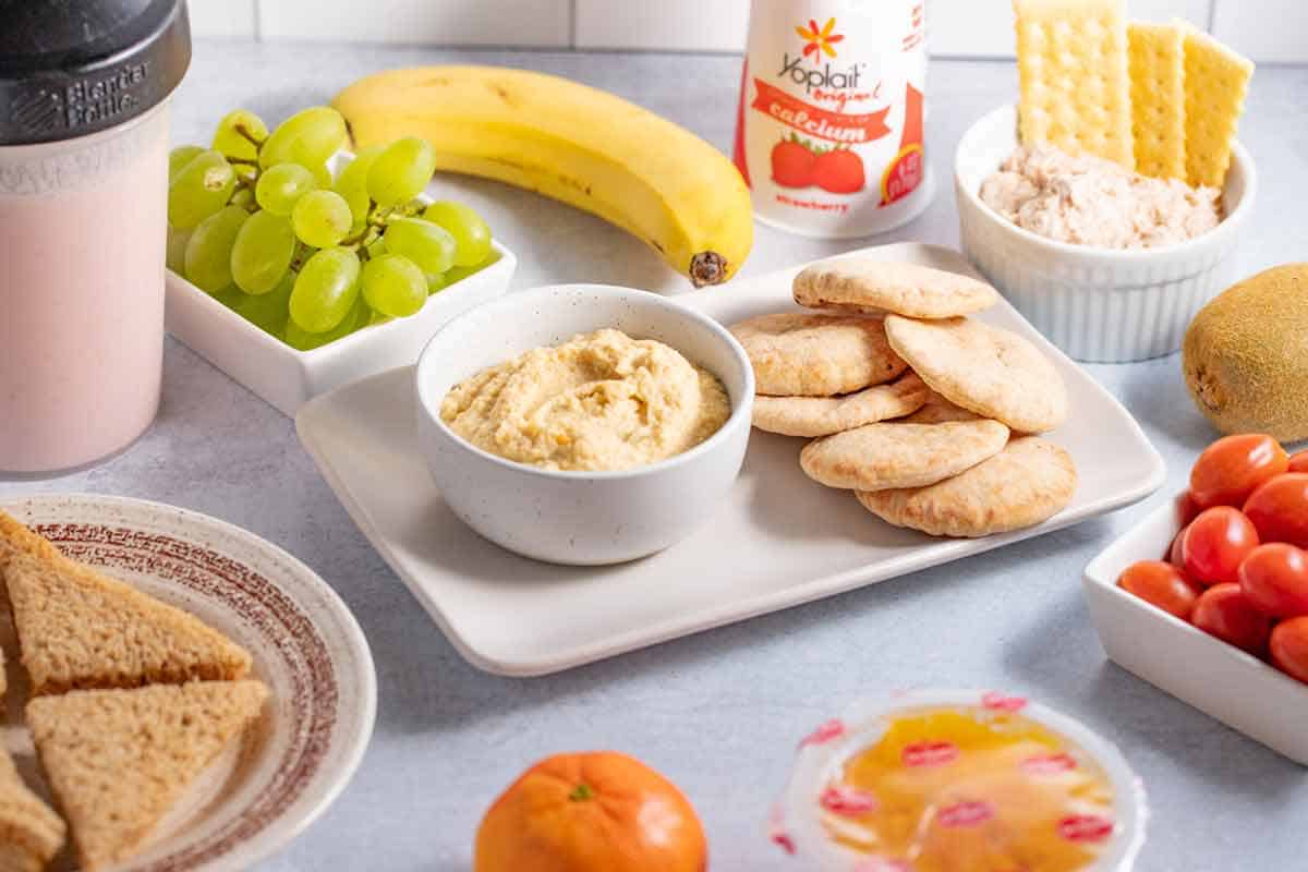 Healthy snacks for kids with braces like a banana, grapes, hummus, or yogurt.