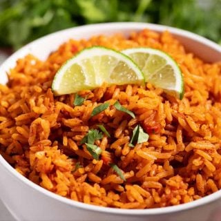 bowl of copycat Taco Bell seasoned rice with lime wedges