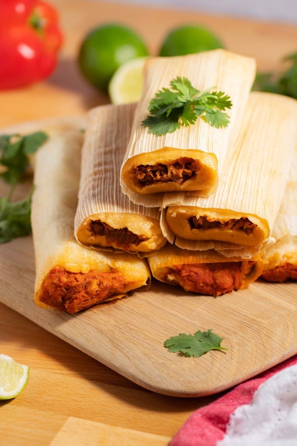 stacked tamales on cutting board