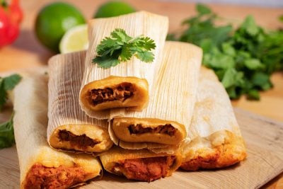 stack of tamales with cilantro