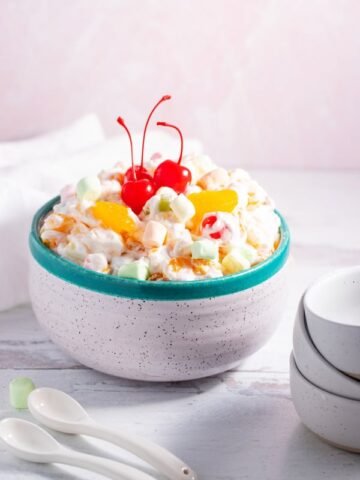 bowl of ambrosia salad set out with serving dishes