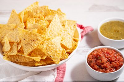 bowl of chips and red and green salsa