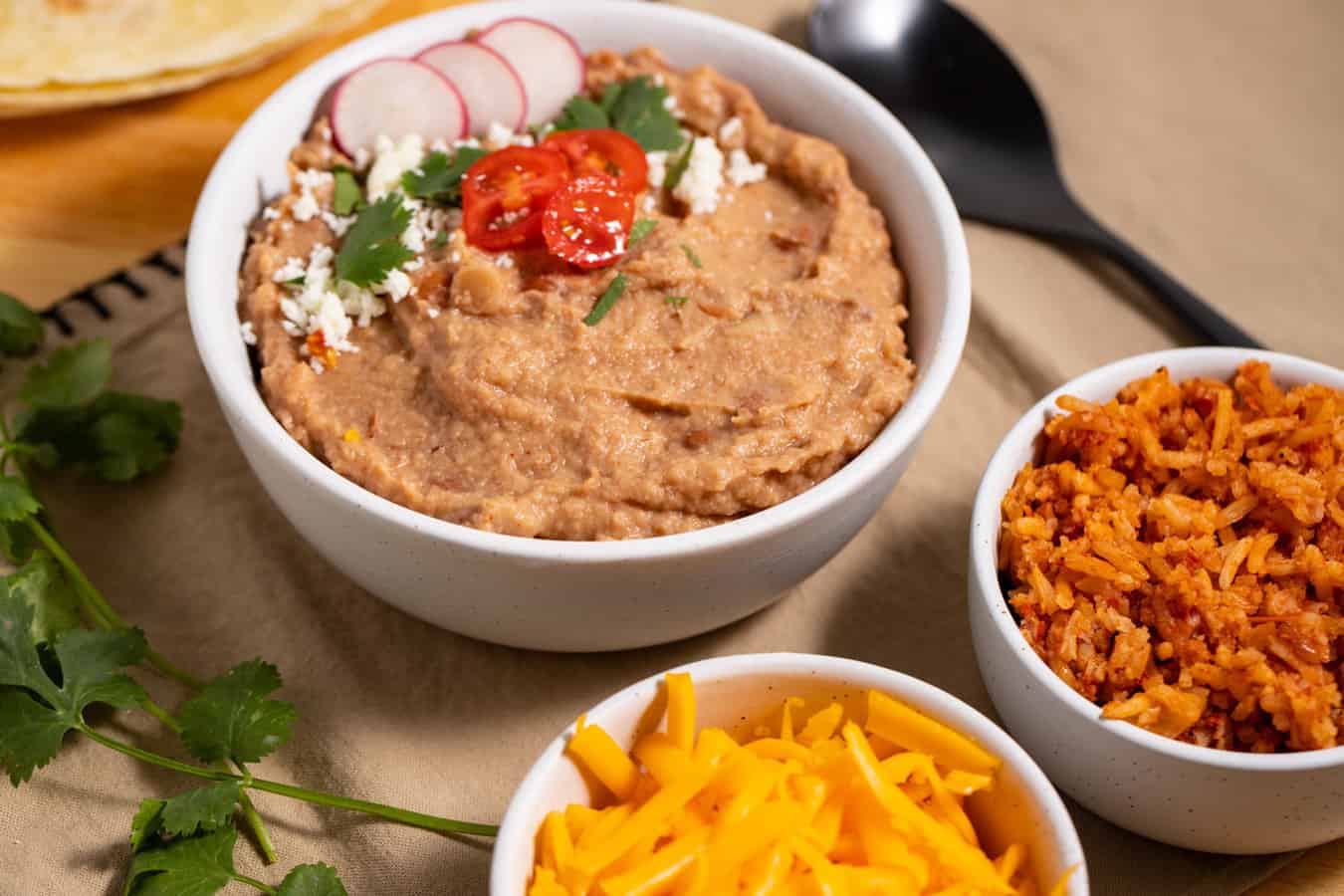 bowl of refried beans with garnish
