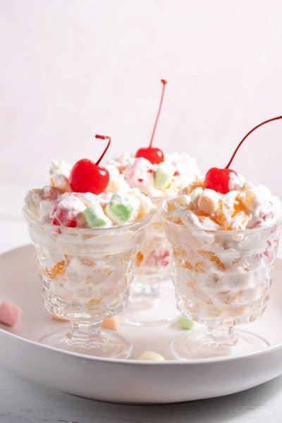 3 serving dishes with ambrosia salad with cool whip