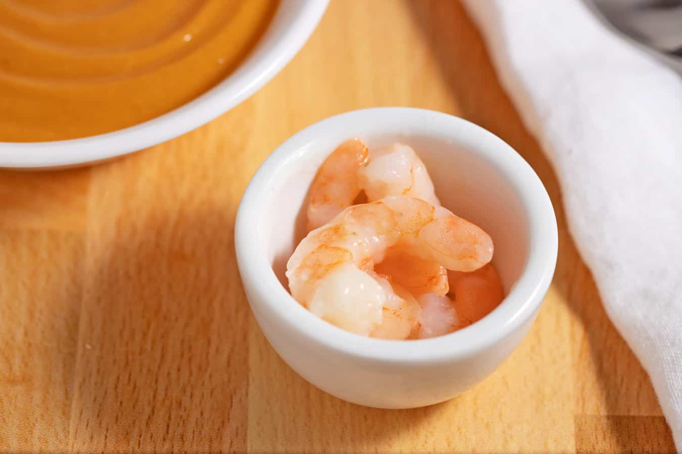 bowl of shrimp next to bowl of butternut squash soup
