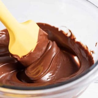 yellow spatula stirring melted chocolate