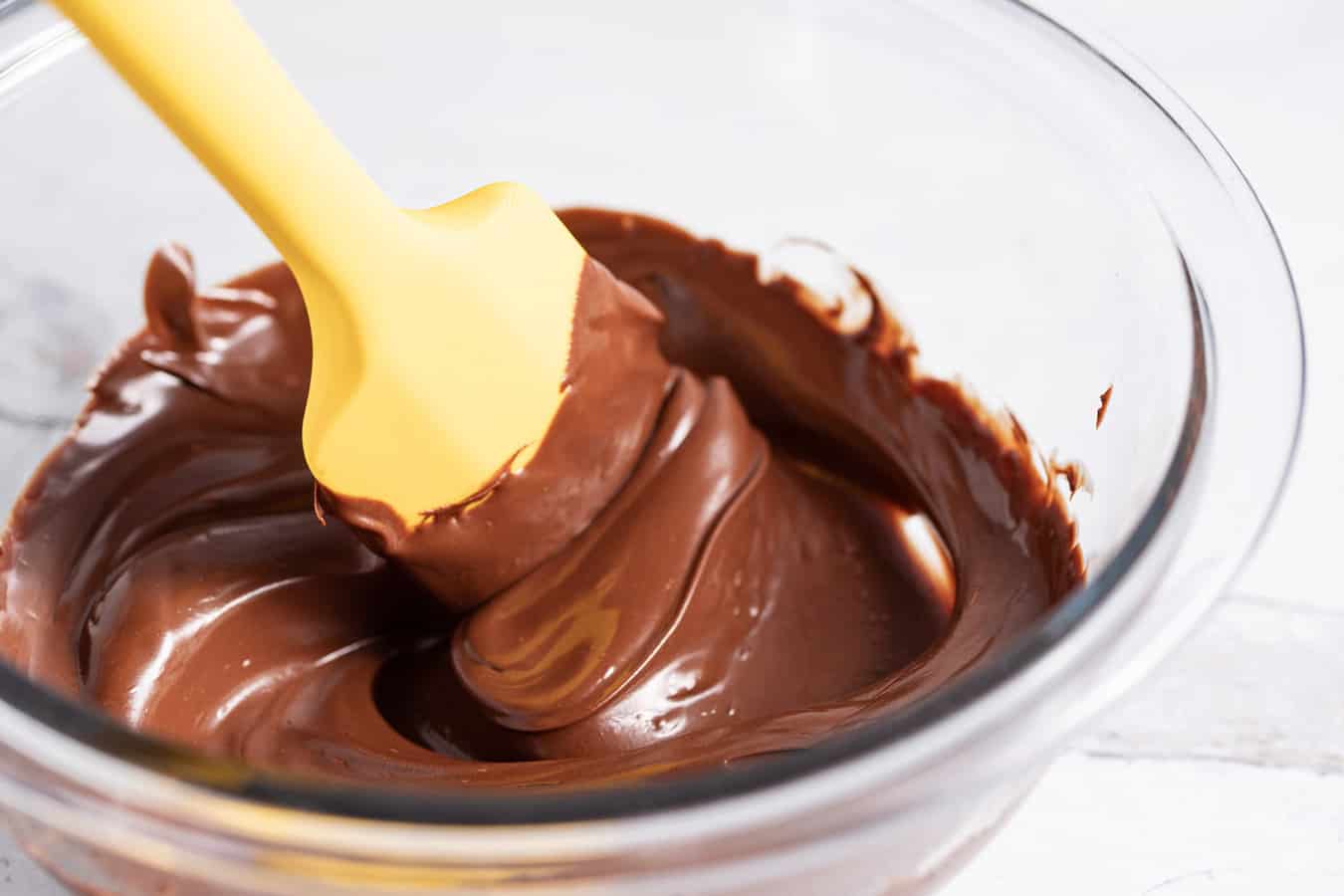 yellow spatula stirring melted chocolate