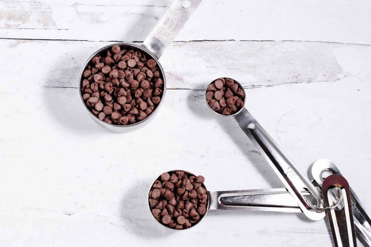 measuring cup and measuring spoons with mini chocolate chips