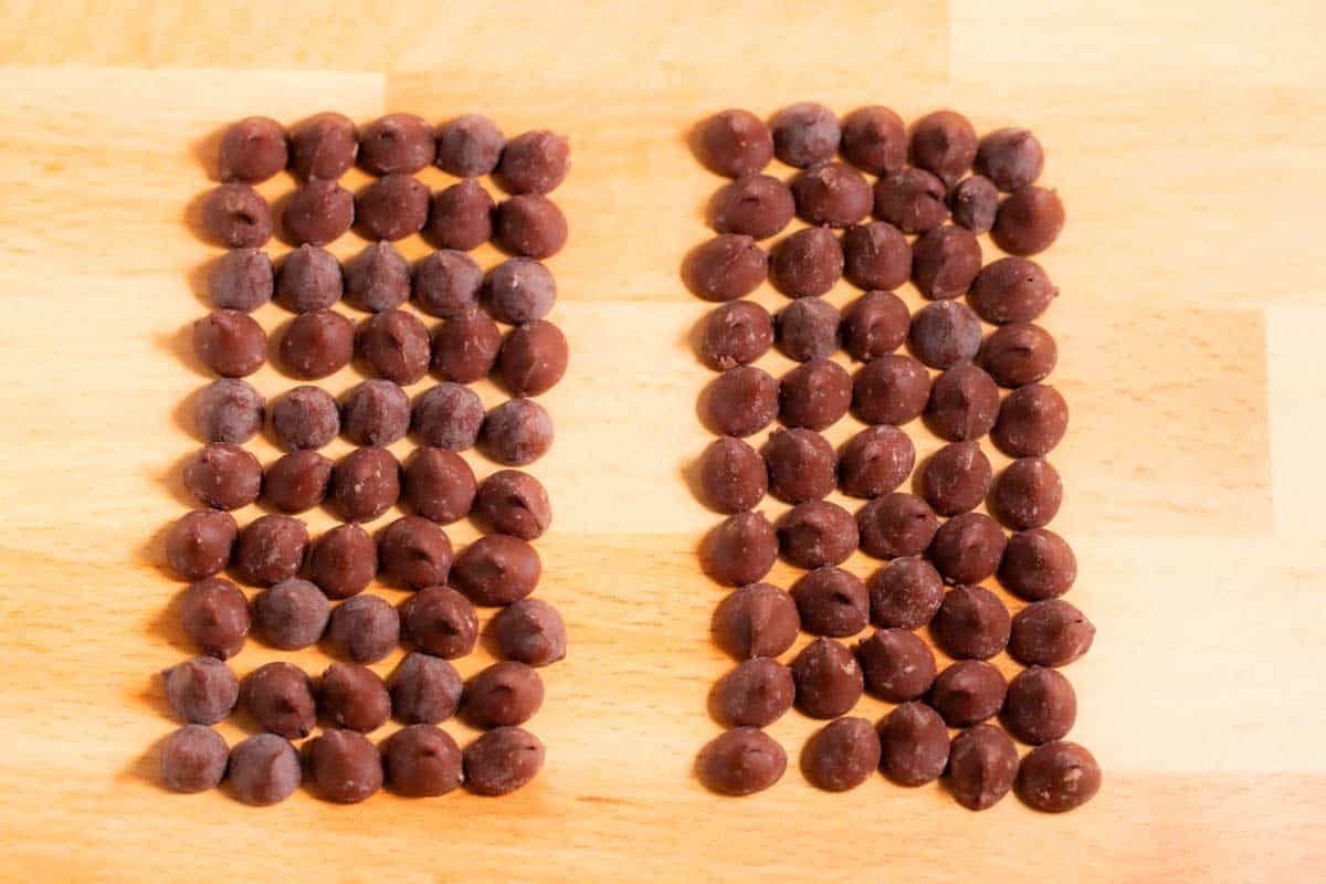 Chocolate chips lined up in columns in a single layer.