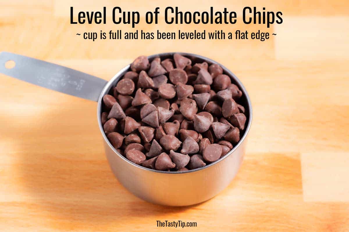Level cup of chocolate chips on the counter.