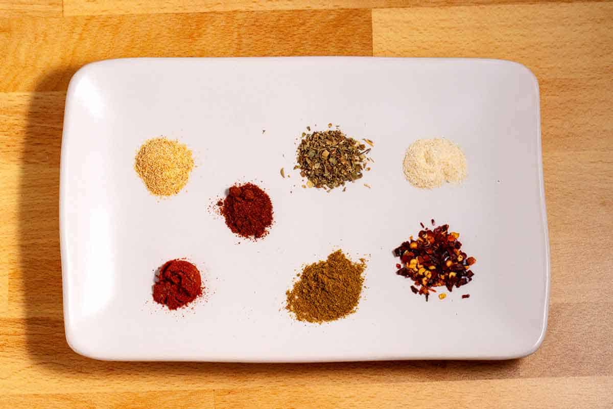 Spices in piles on a plate.