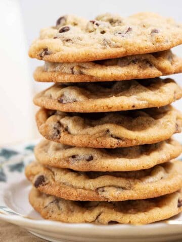 Stack of chocolate chip cookies on a plate.