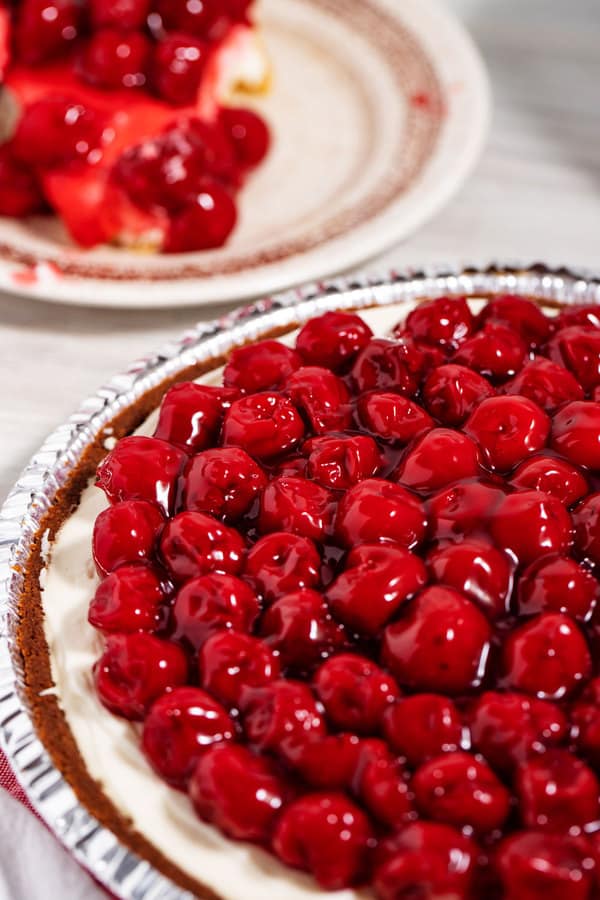 whole cherry pie recipe with canned filling and graham cracker crust next to slice of pie