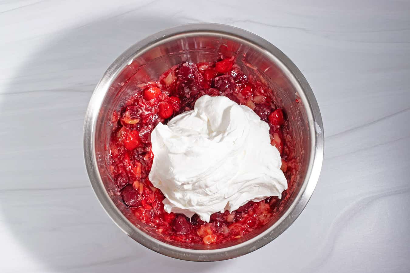 adding cool whip to cherry fluff salad