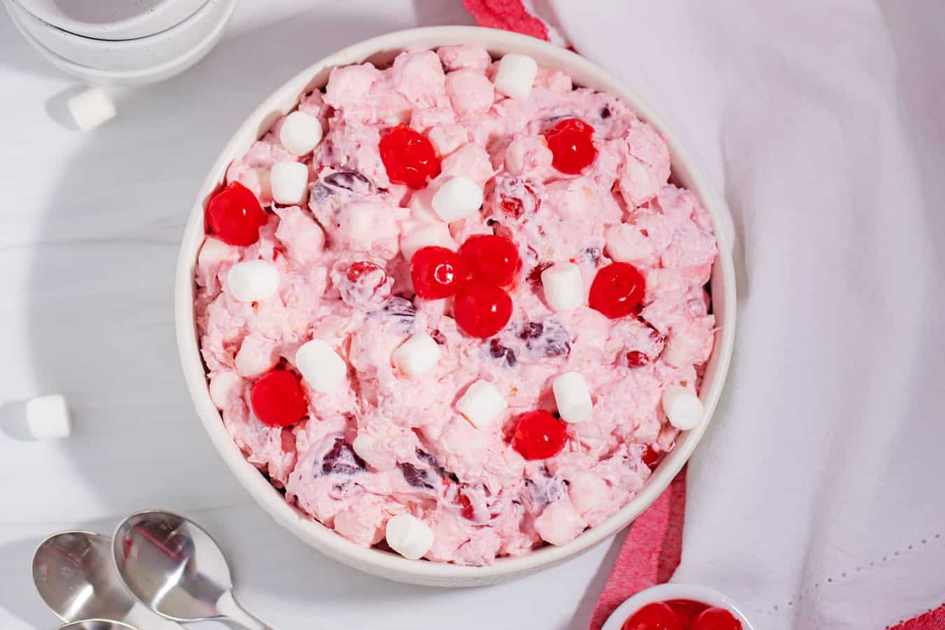 bowl of cherry fluff salad recipe without sweetened condensed milk with bowls and spoons