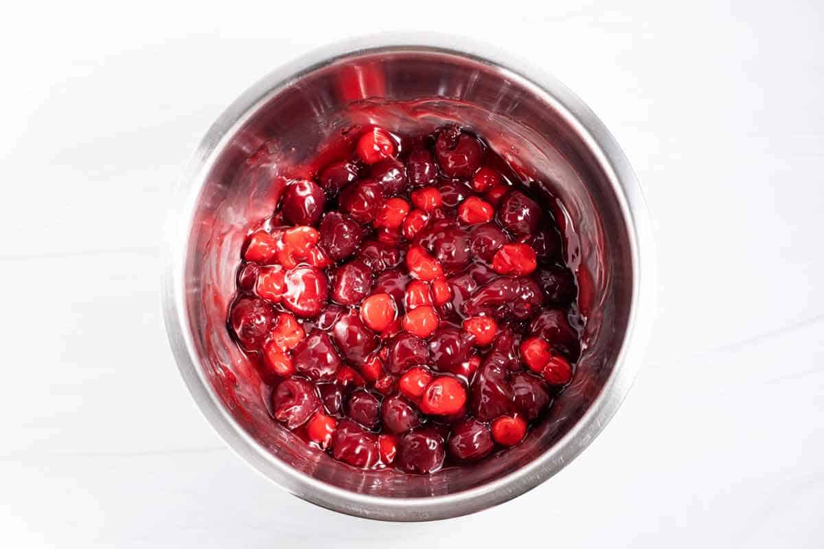 Cherry pie filling and canned cherries mixed together in a bowl.