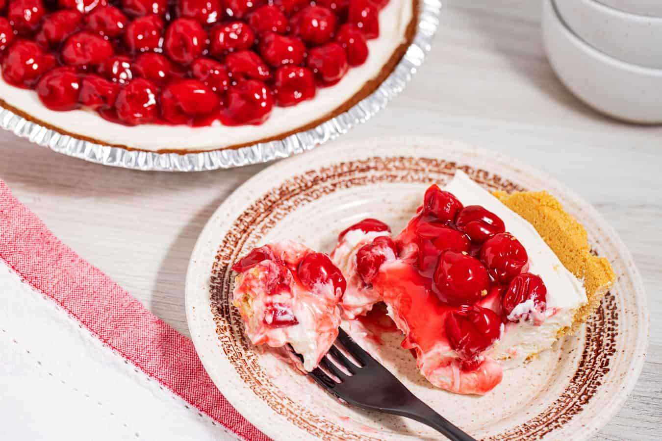 slice of cherry pie next to whole pie