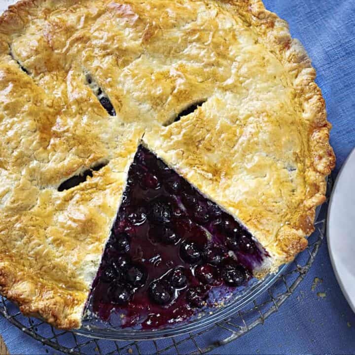 blueberry pie with slice of pie cut out