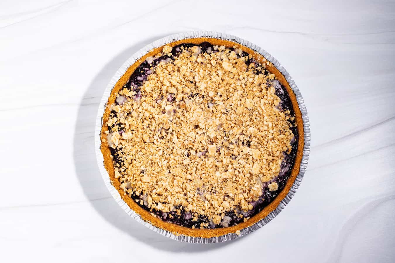 Blueberry pie with streusel topping and premade graham cracker crust.