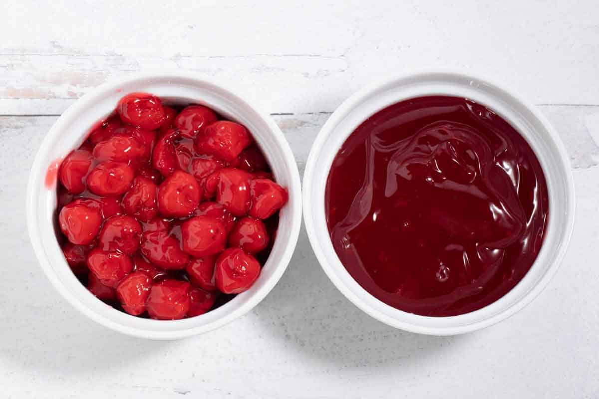 bowl of canned cherries and bowl of syrupy gel from canned cherry pie filling