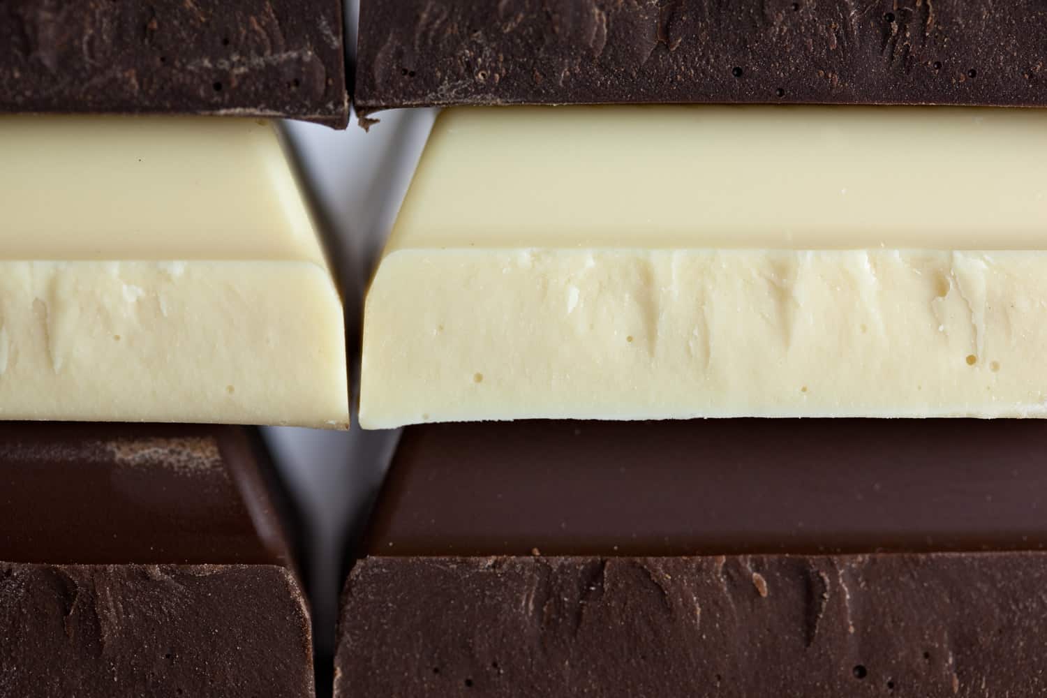 White chocolate bar and dark chocolate bar stacked.