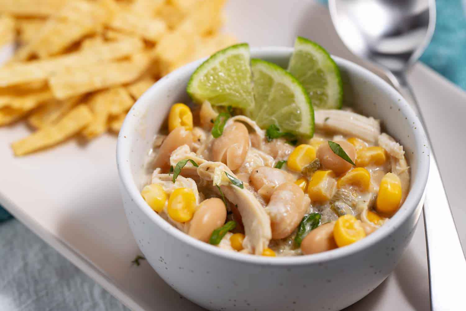 bowl of white chicken chili with salsa verde recipe and tortilla chips