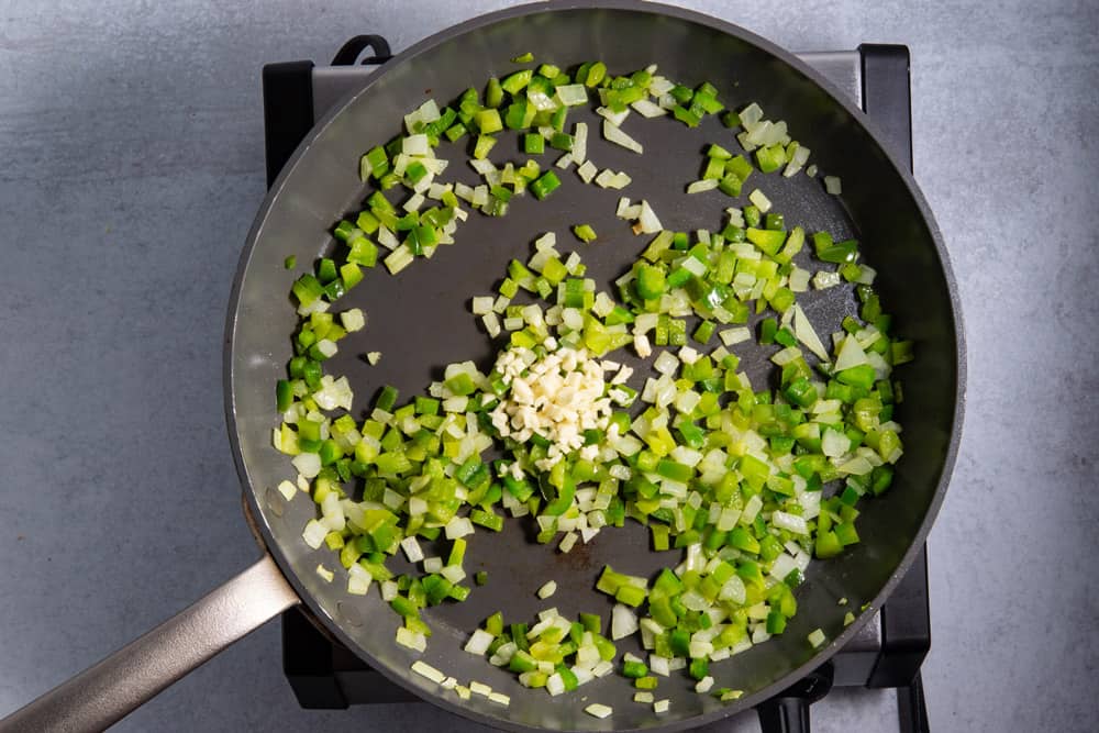 jalapenos, onions, garlic, green peppers in frying pan