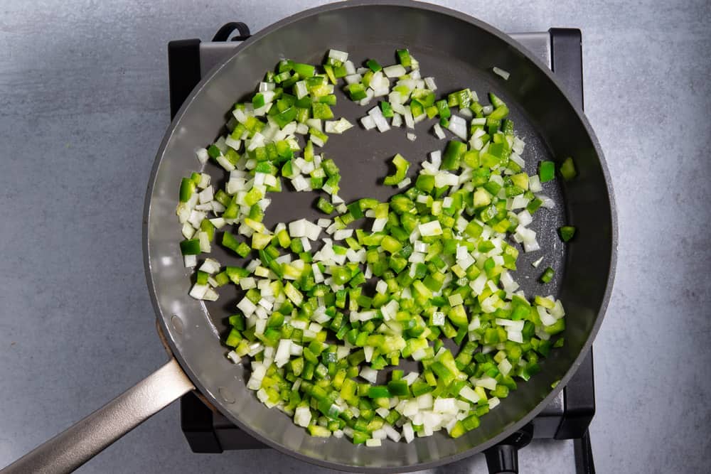 jalapenos, onions, green peppers in frying pan