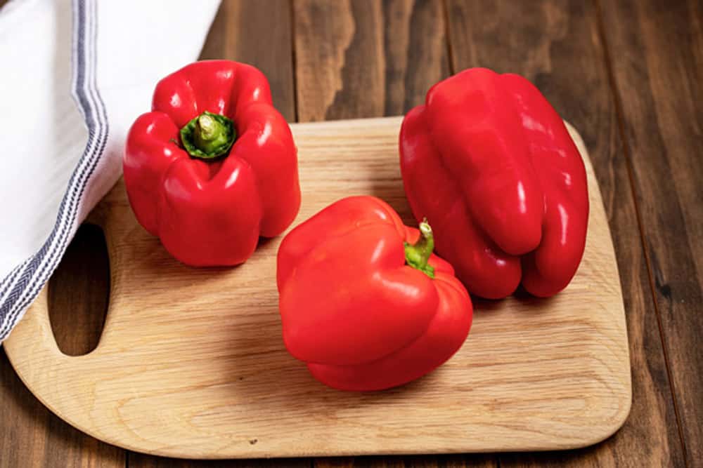 red bell peppers on a cutting board