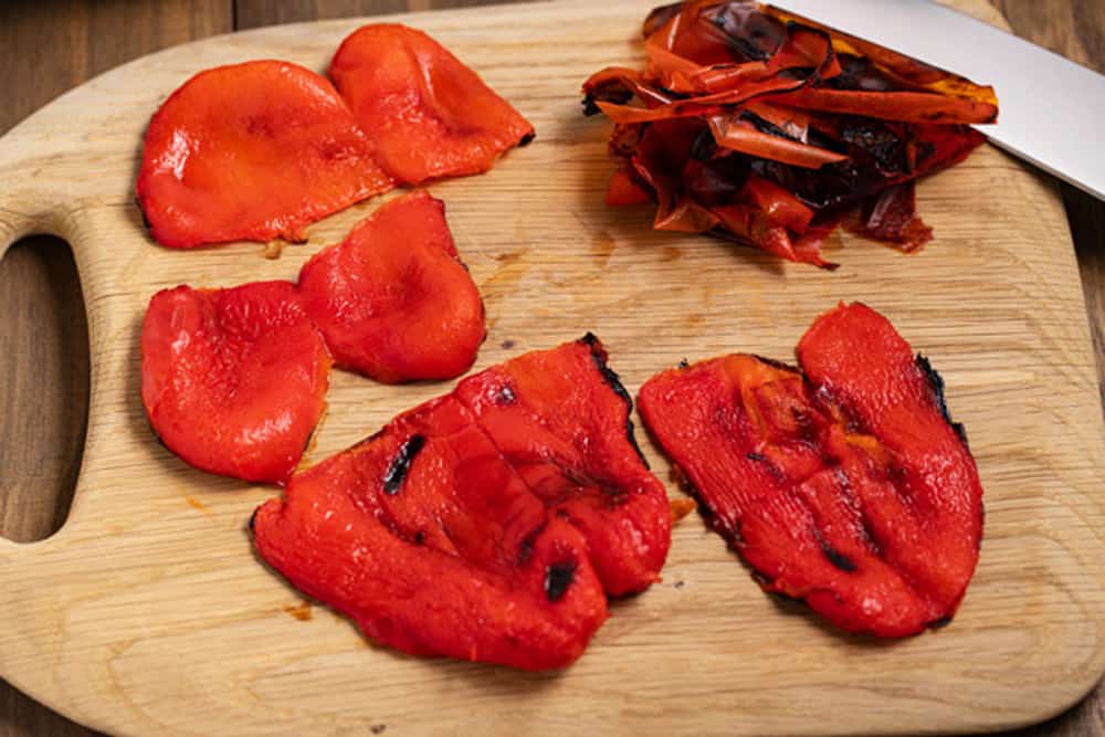 roasted red peppers on a cutting board
